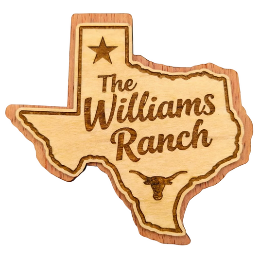Wooden Texas-shaped magnet with 'The Williams Ranch' engraving on a white background