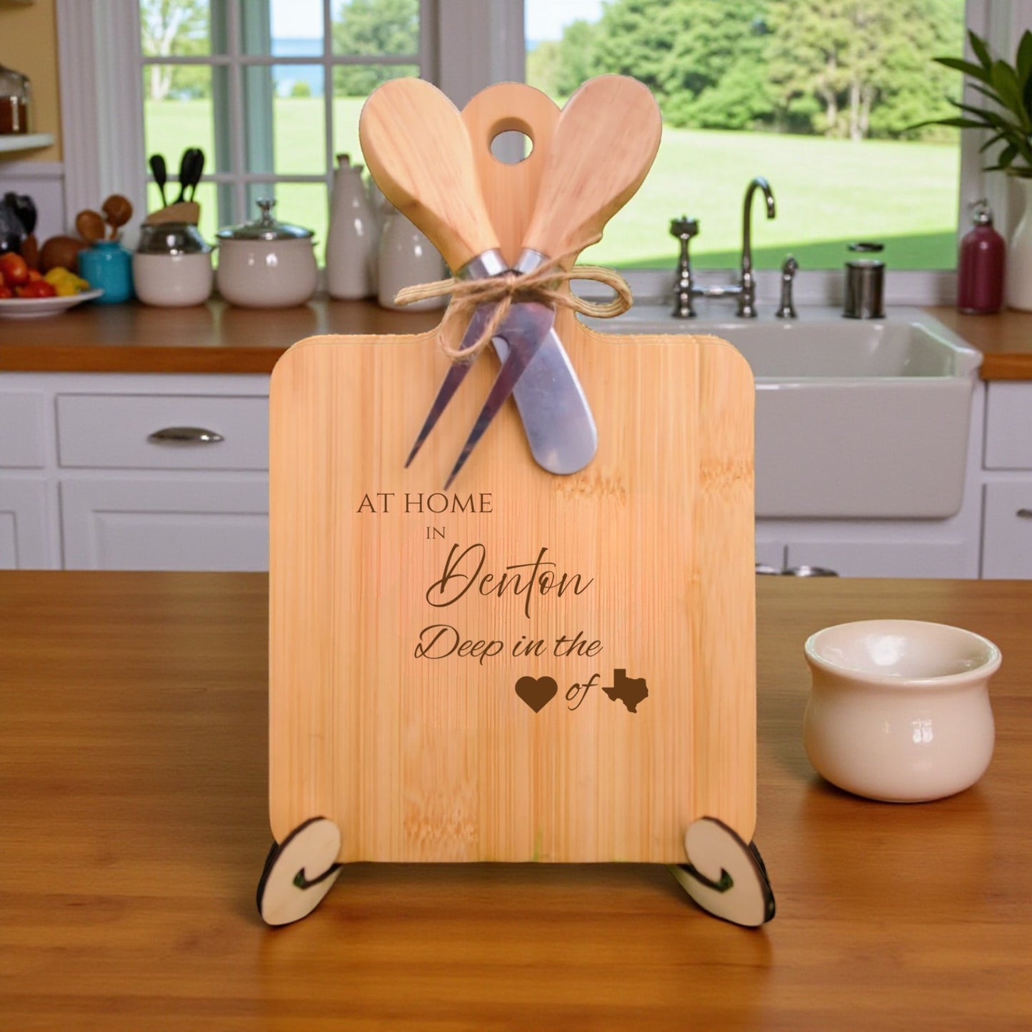 The At Home in Denton Charcuterie Board with laser-engraved Texas silhouette and “At Home in Denton” text, displayed in a cozy kitchen, ideal for entertaining and Texas pride.