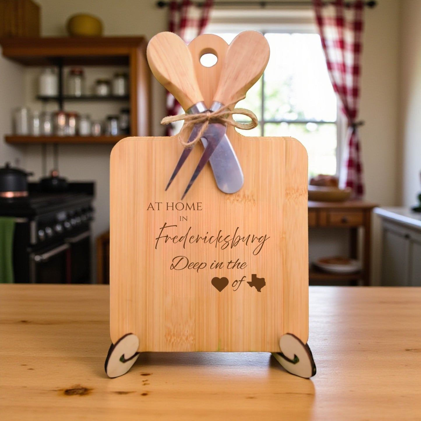 The At Home in Fredericksburg Charcuterie Board with laser-engraved Texas silhouette and “At Home in Fredericksburg” text, displayed in a warm kitchen, ideal for entertaining and Texas pride.