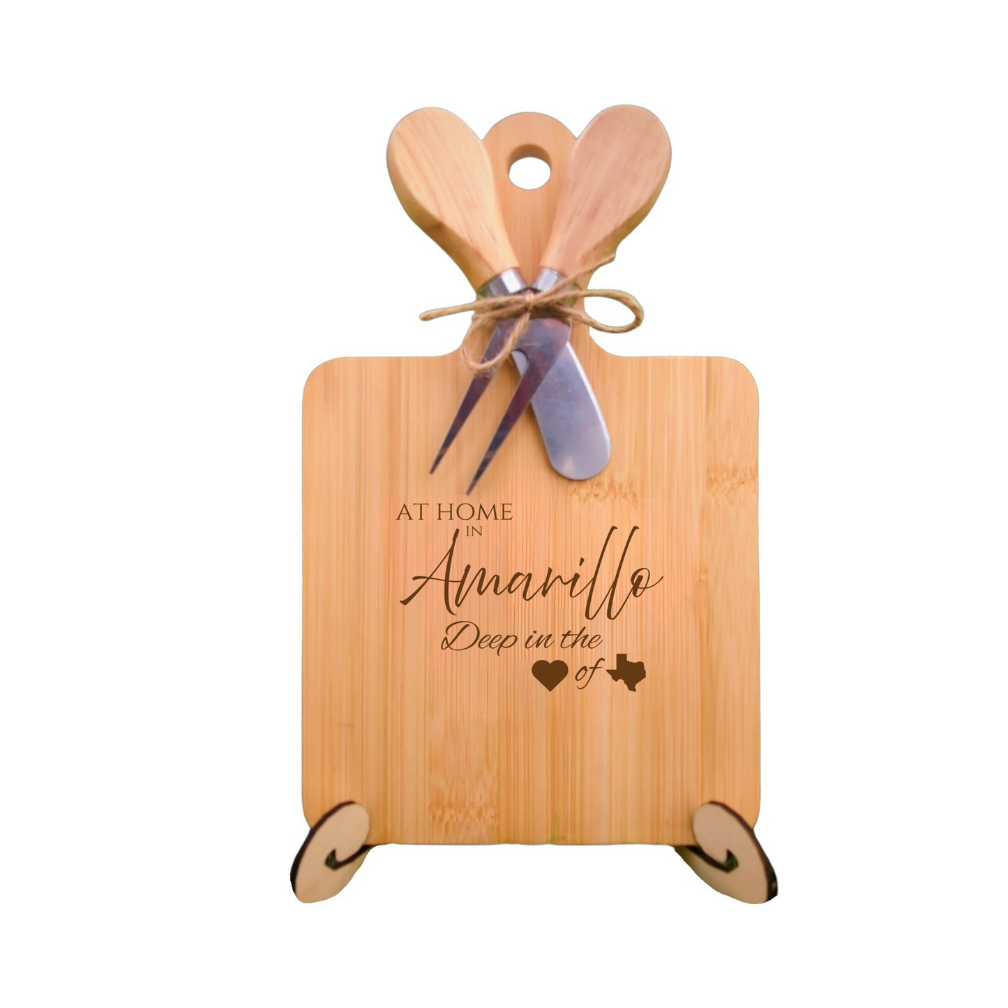 bamboo charcuterie board with utensils, engraved with “At Home in Amarillo, Deep in the Heart of Texas.”