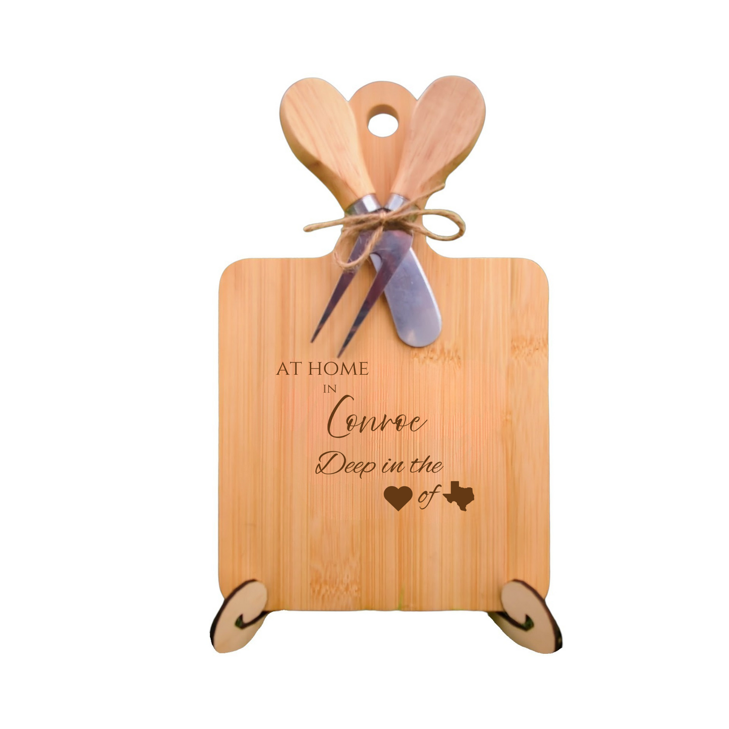 Elegant bamboo charcuterie board with utensils, engraved with “At Home in Conroe, Deep in the Heart of Texas.”