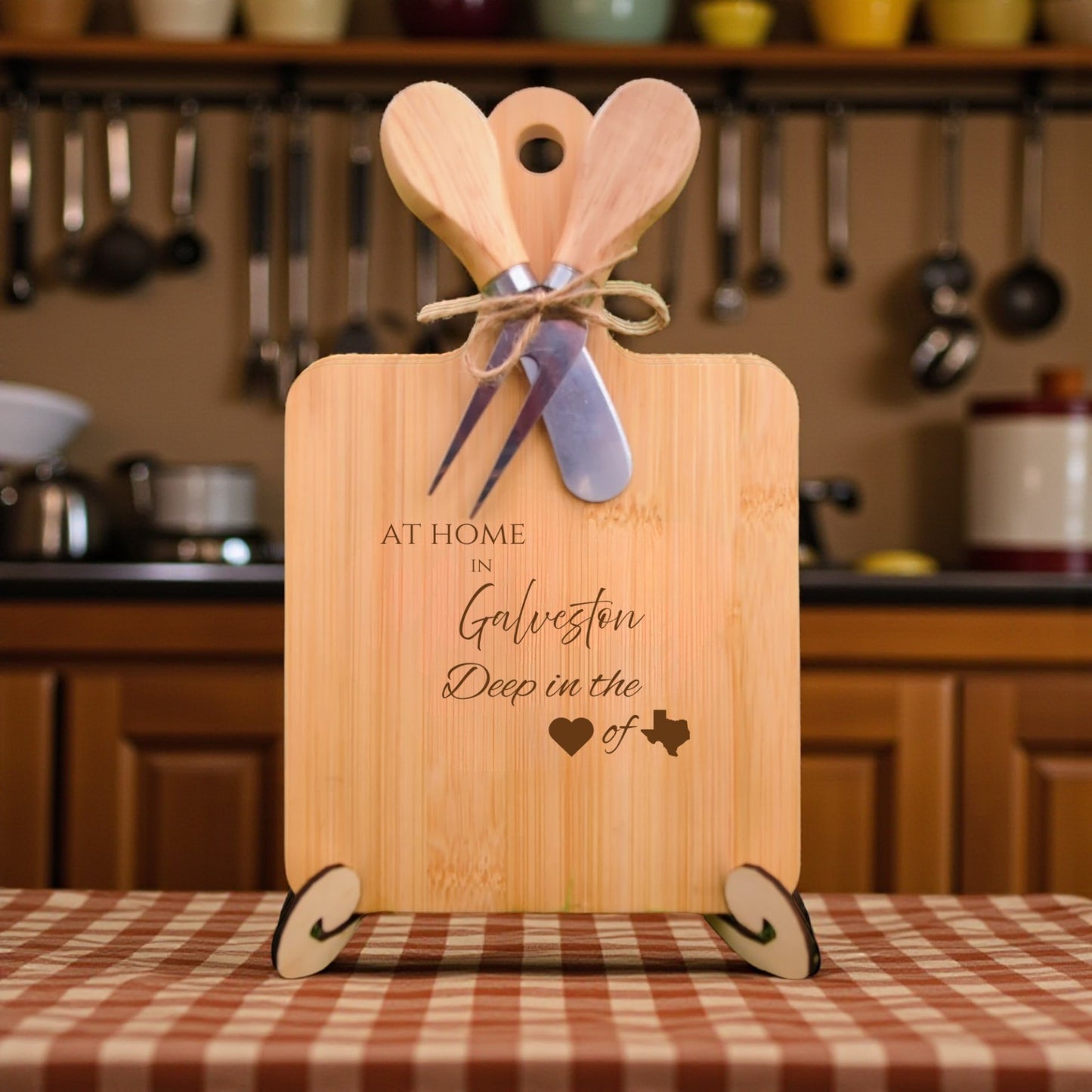 Bamboo charcuterie board engraved with “At Home in Galveston, Deep in the Heart of Texas” displayed in a kitchen setting.