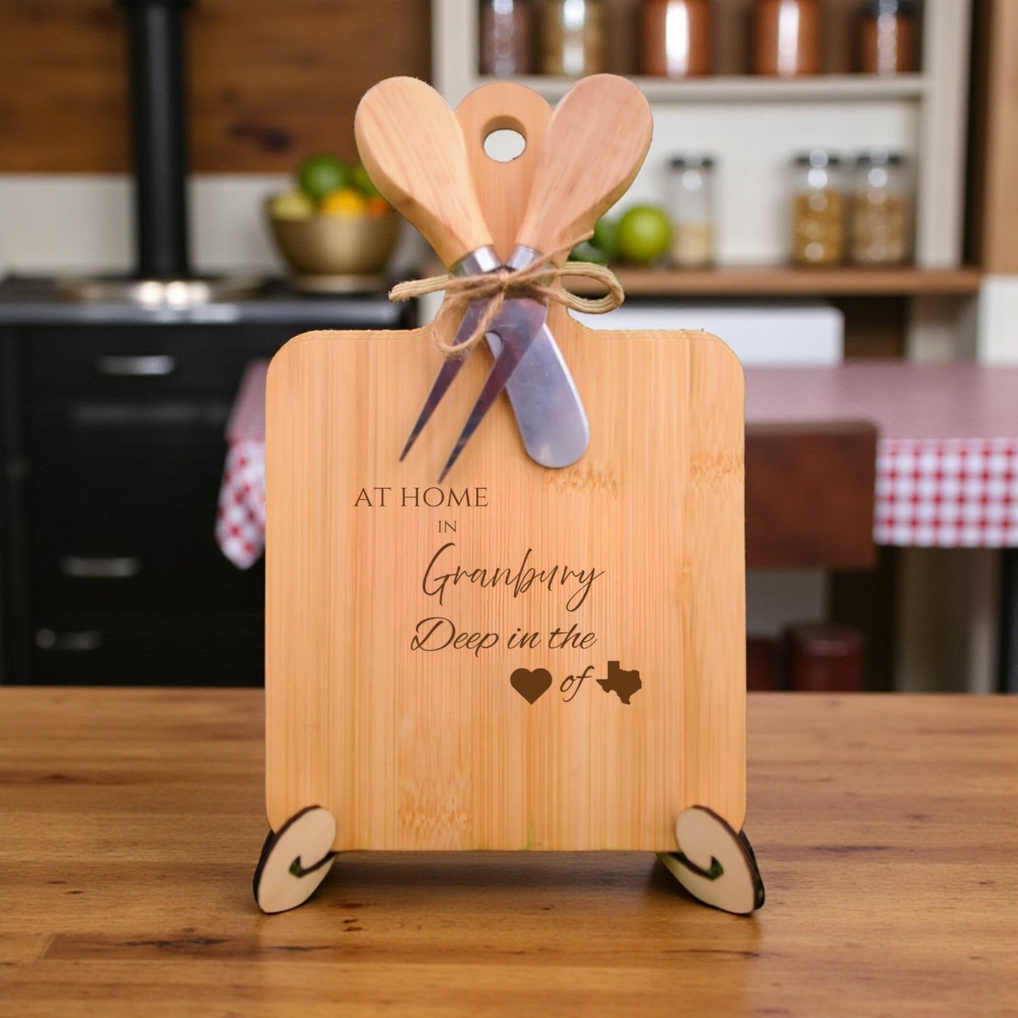 Bamboo charcuterie board engraved with “At Home in Granbury, Deep in the Heart of Texas” displayed in a kitchen setting.