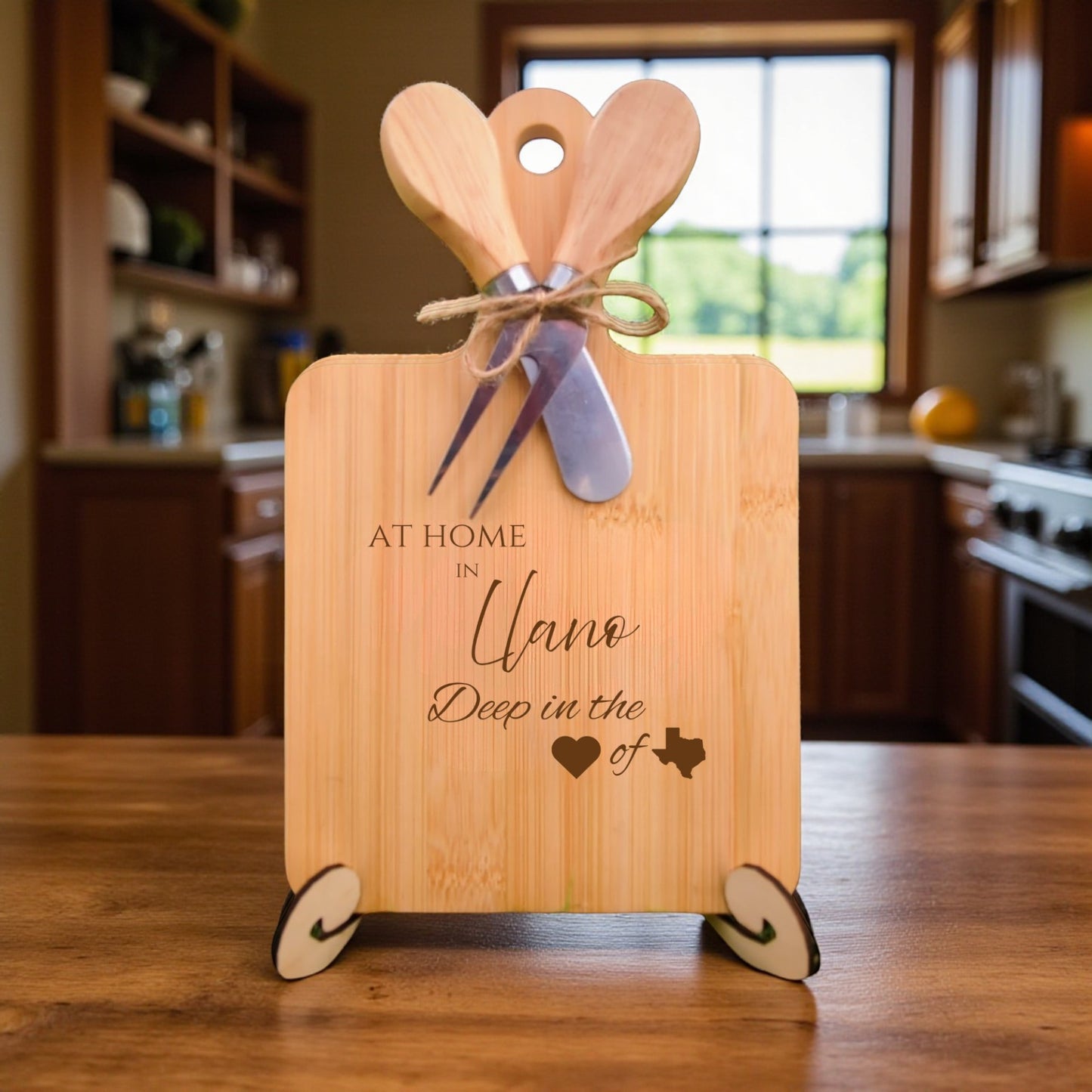 Bamboo charcuterie board engraved with “At Home in Llano, Deep in the Heart of Texas” displayed in a kitchen setting.