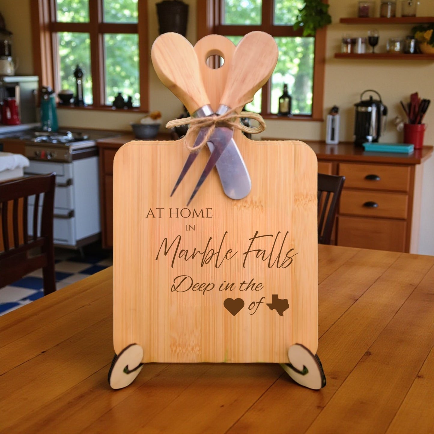 Bamboo charcuterie board engraved with “At Home in Marble Falls, Deep in the Heart of Texas” displayed in a kitchen setting.