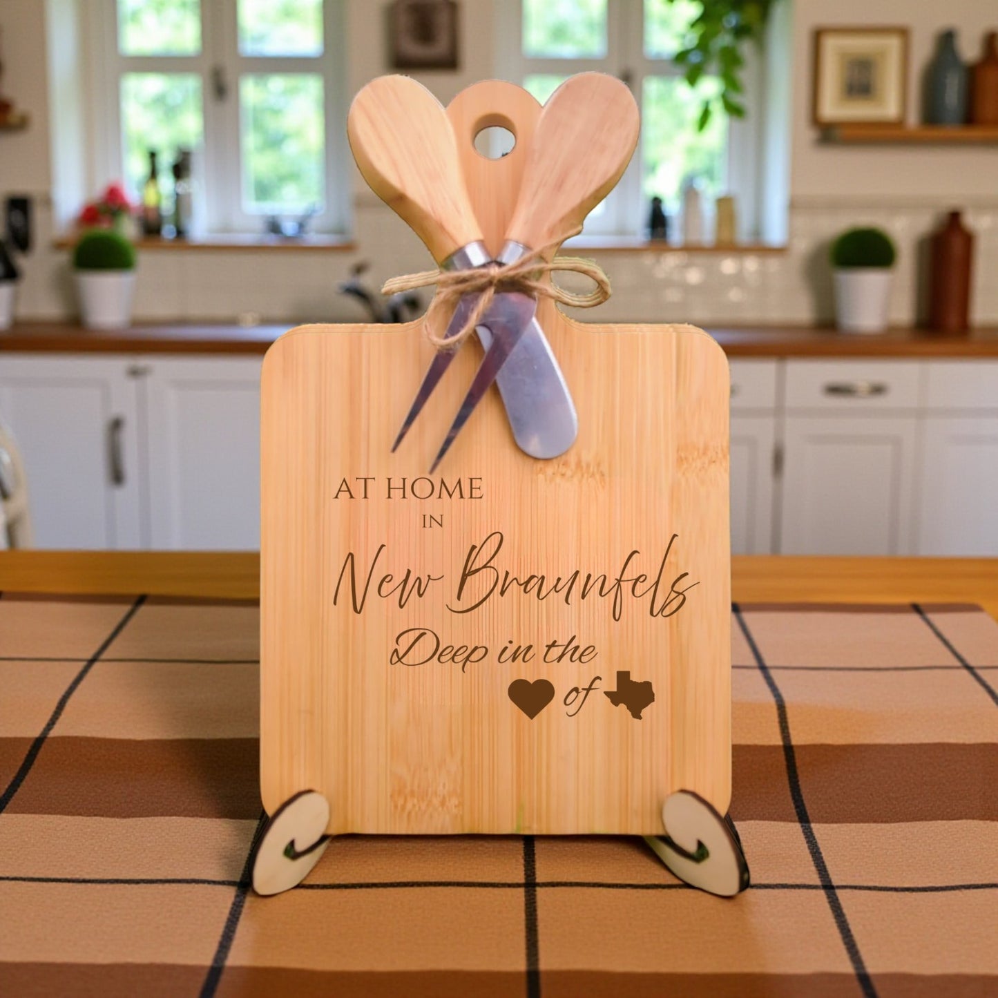 Bamboo charcuterie board engraved with “At Home in New Braunfels, Deep in the Heart of Texas” displayed in a kitchen setting.