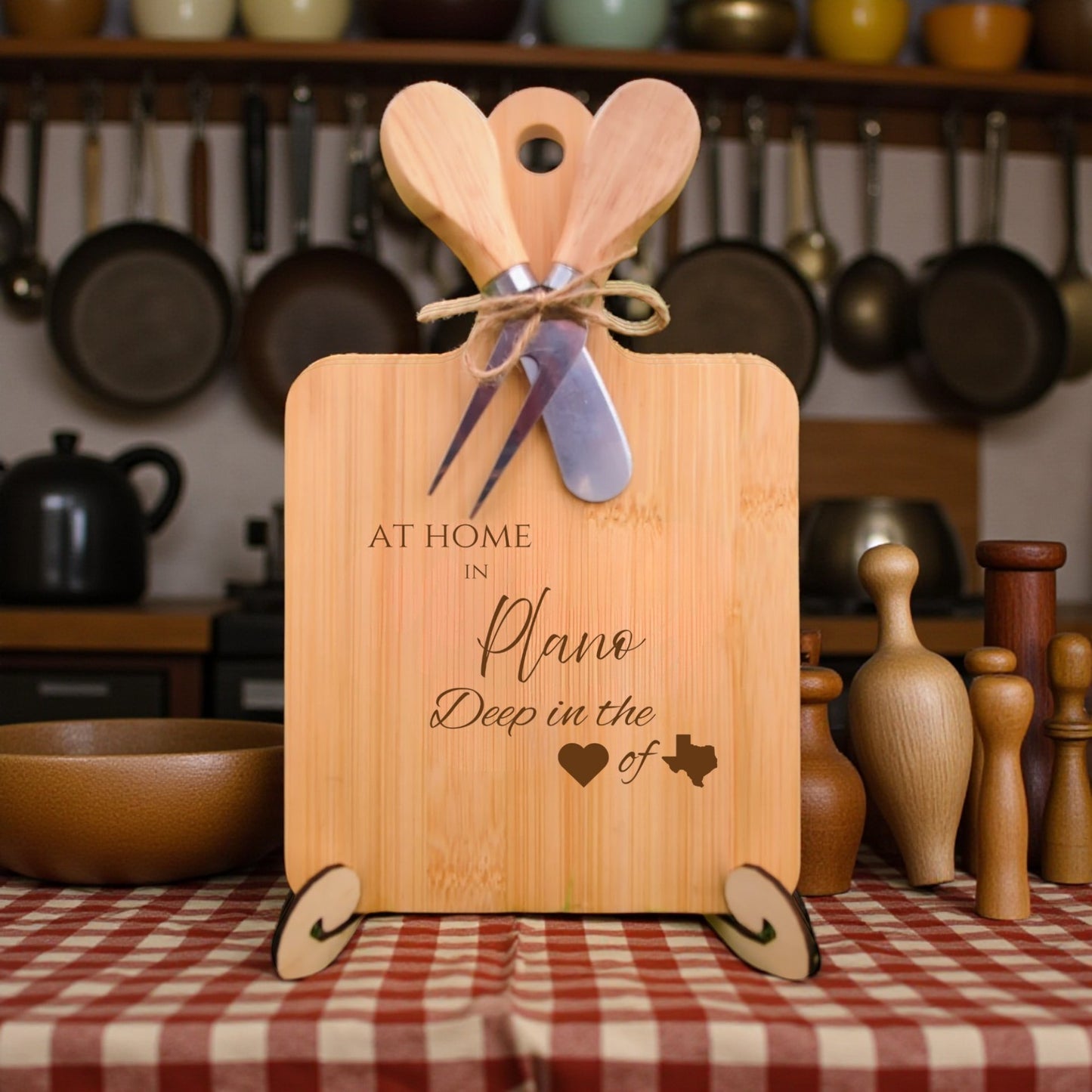 Bamboo charcuterie board engraved with “At Home in Plano, Deep in the Heart of Texas” displayed on a dining table with kitchen décor.