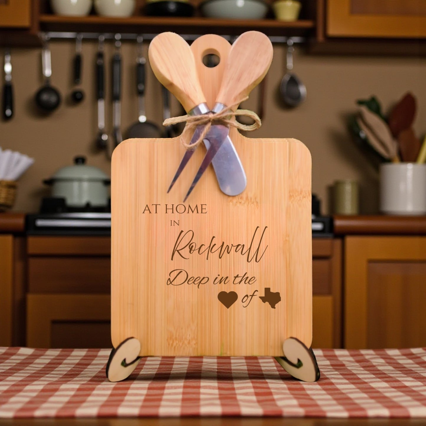 Bamboo charcuterie board engraved with “At Home in Rockwall, Deep in the Heart of Texas” displayed in a kitchen setting.