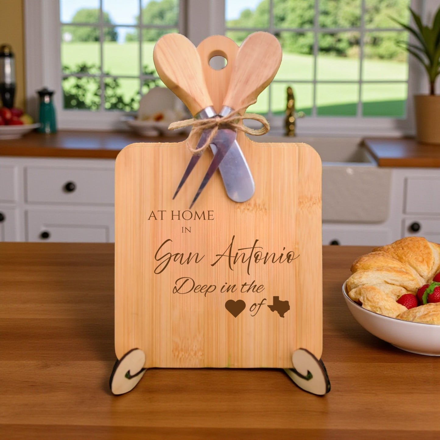 Bamboo charcuterie board engraved with “At Home in San Antonio, Deep in the Heart of Texas” displayed in a kitchen setting.