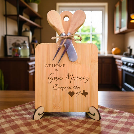 Bamboo charcuterie board engraved with “At Home in San Marcos, Deep in the Heart of Texas” displayed on a kitchen display with rustic décor.