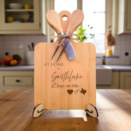 Bamboo charcuterie board engraved with “At Home in Southlake, Deep in the Heart of Texas” displayed in a modern kitchen setting with bright décor.