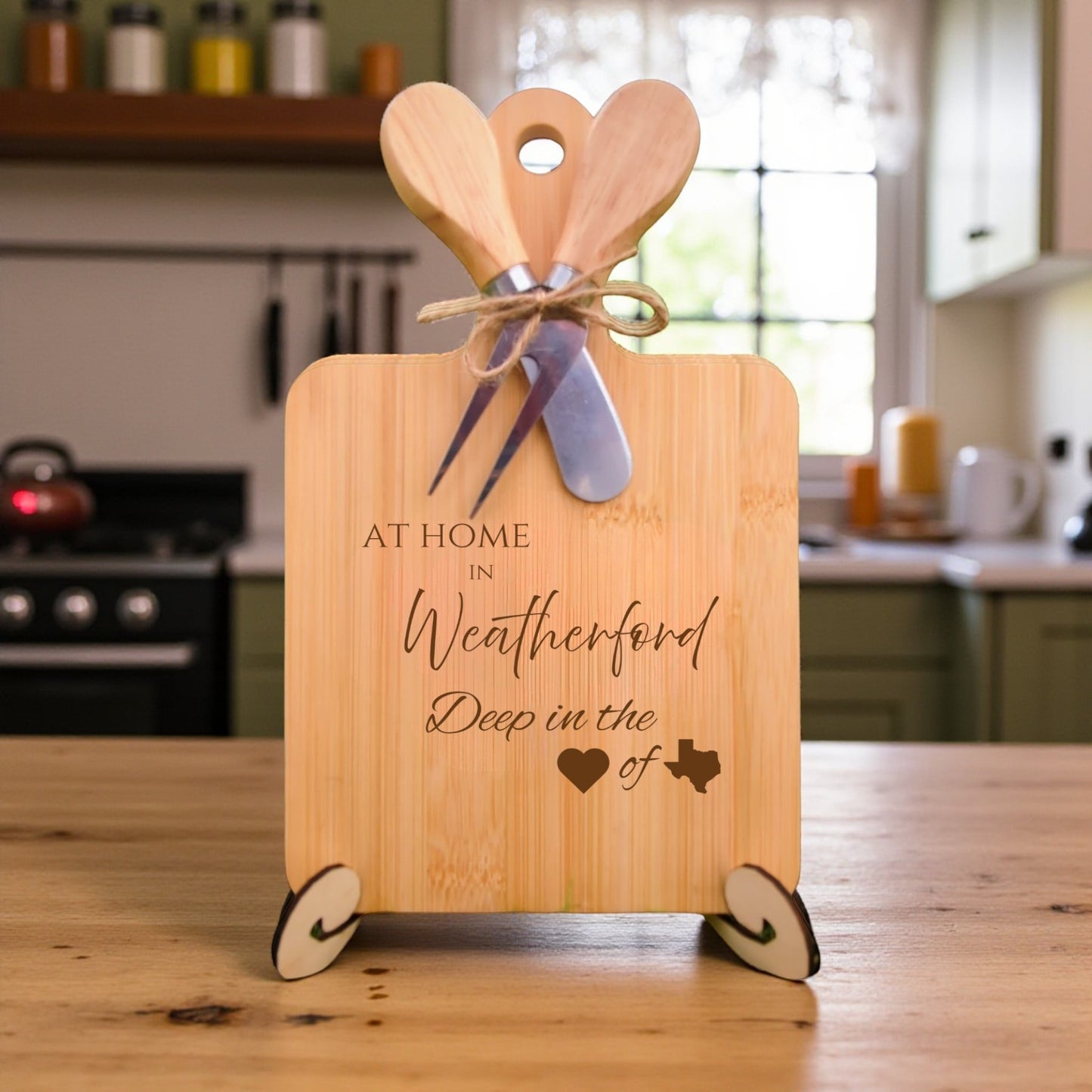 Bamboo charcuterie board engraved with “At Home in Weatherford, Deep in the Heart of Texas” displayed in a kitchen setting.
