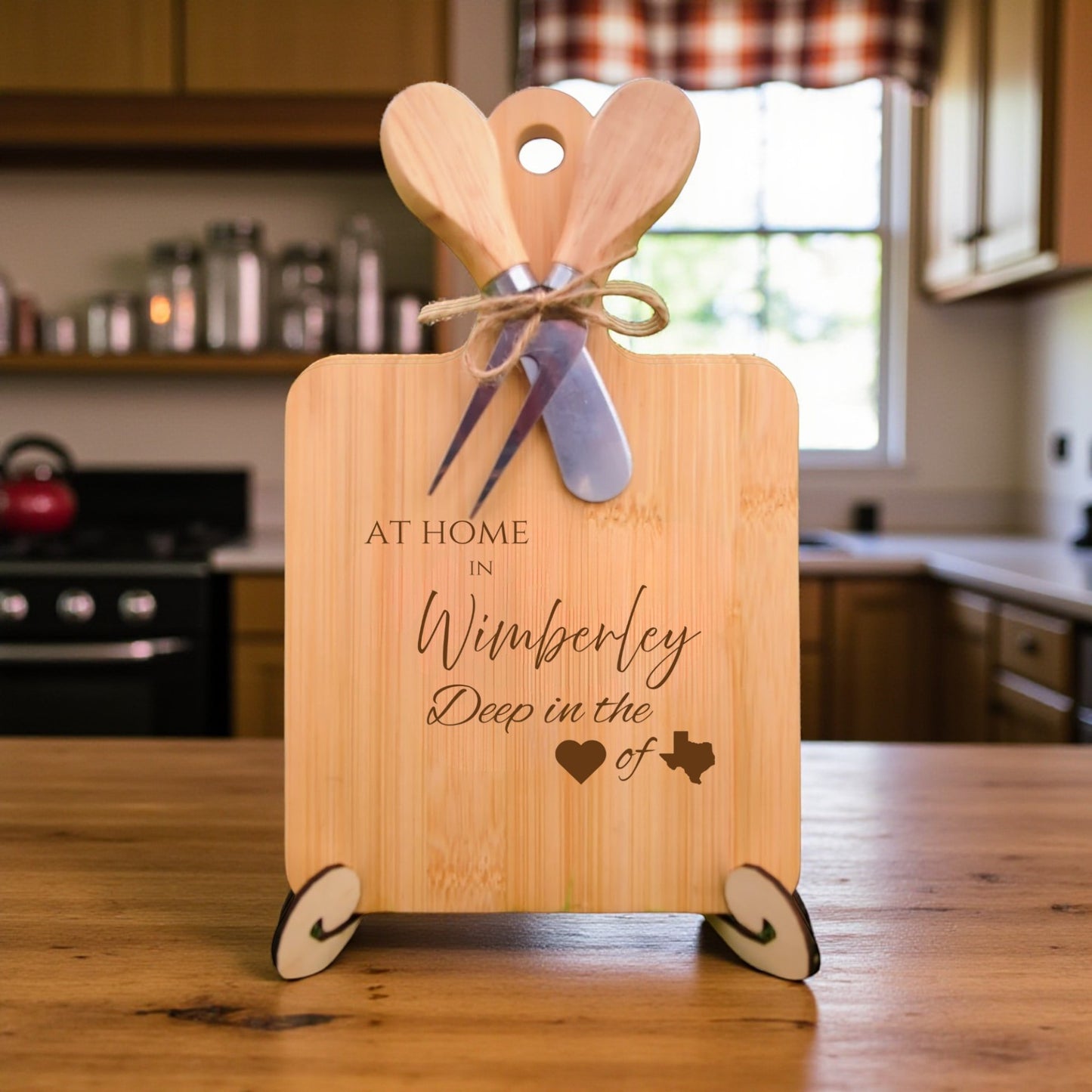 Bamboo charcuterie board engraved with “At Home in Wimberley, Deep in the Heart of Texas” displayed in a kitchen setting.