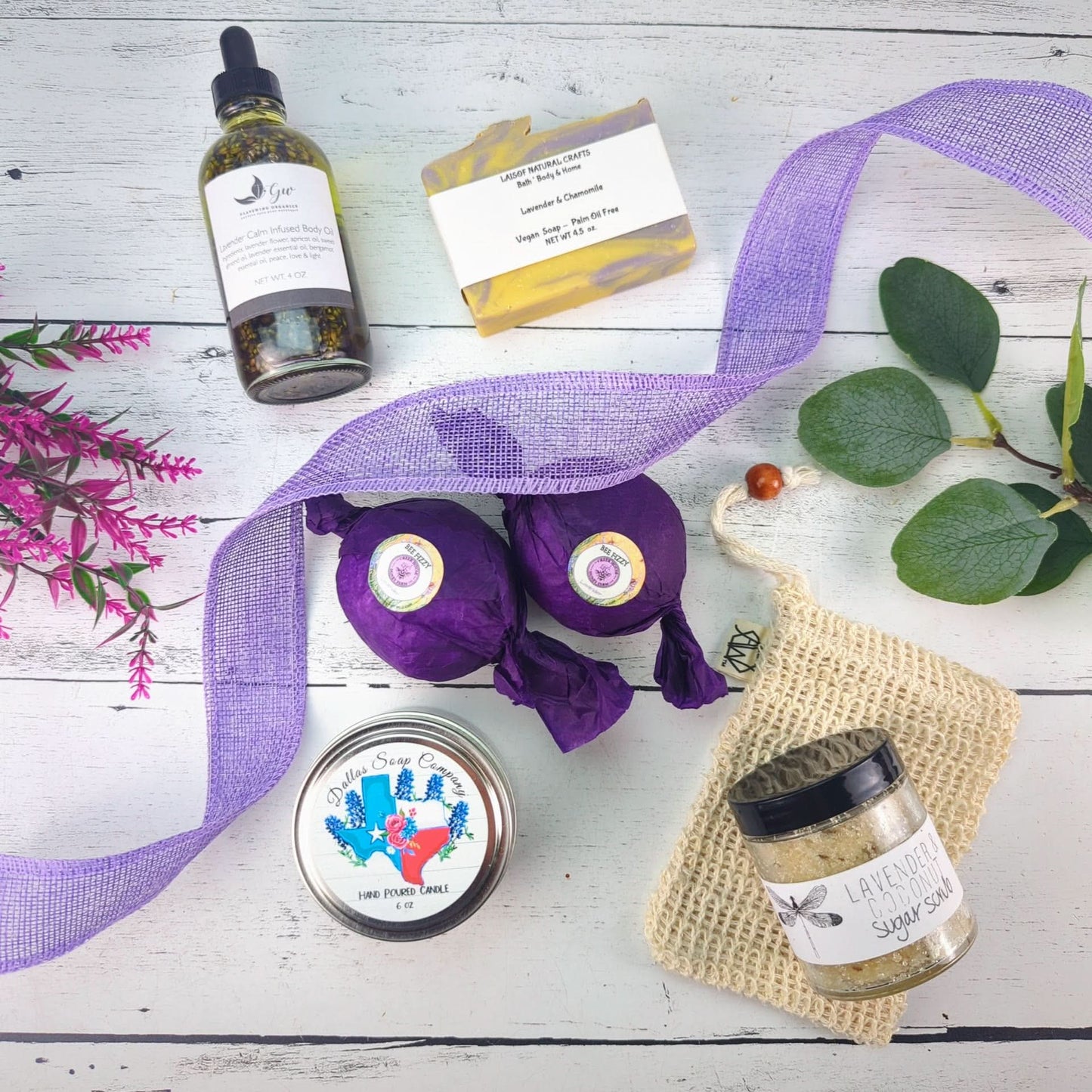 a collection of Texas-made spa items includin soap, bath bombs, sugar scrub, candle, and body oil
