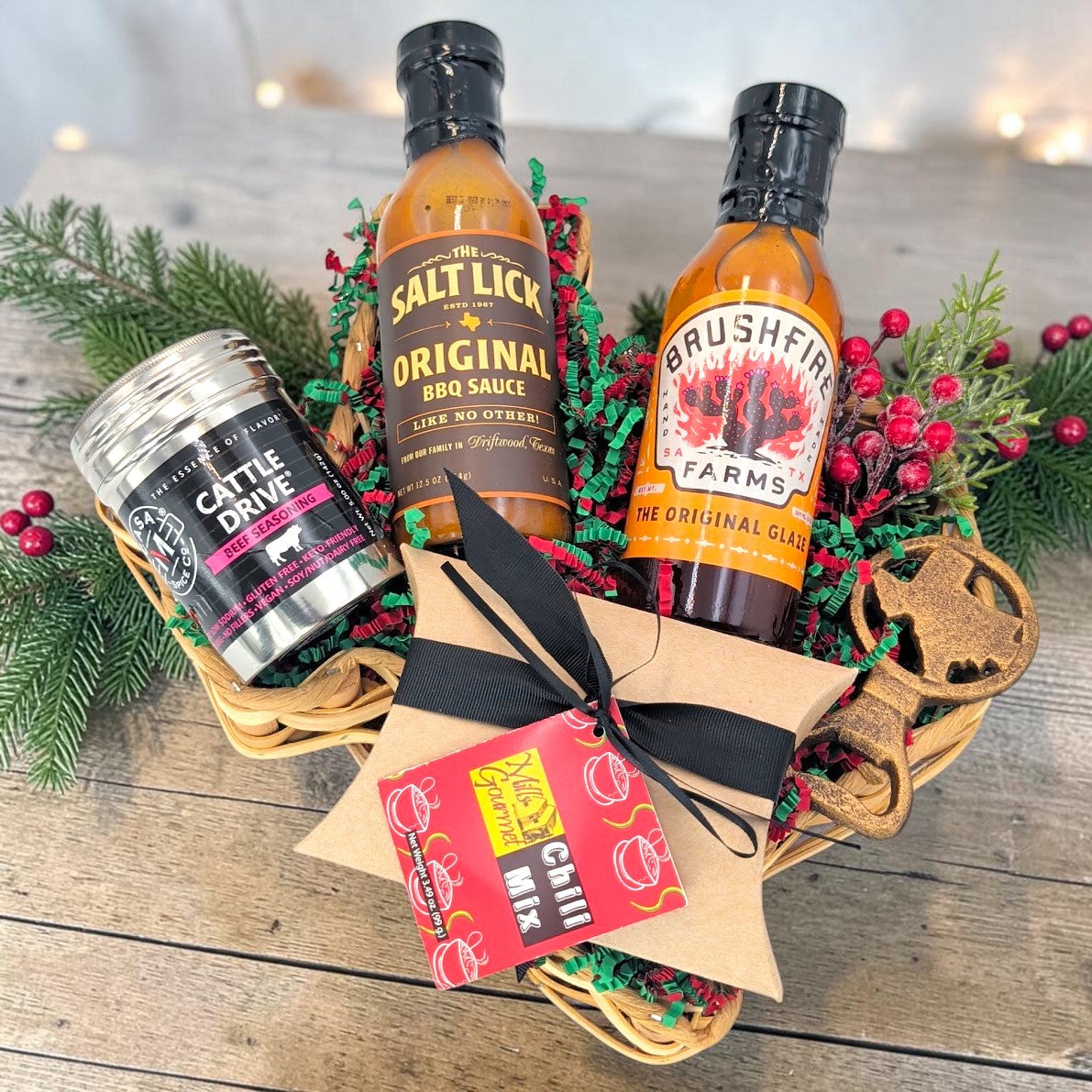 Texas Christmas Cookout with barbecue sauce, glaze, beef seasoning, chili mix and a Texas bottle opener in a small Texas-shaped basket.