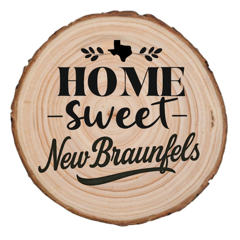 Natural wood slice coaster with “Home Sweet New Braunfels” laser engraving and Texas silhouette on white background.