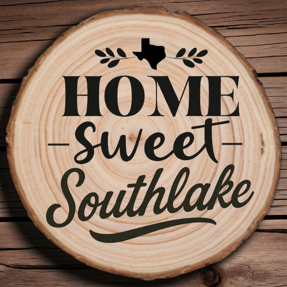 Rustic wood slice coaster with “Home Sweet Southlake” laser engraving, Texas silhouette, and leafy accents on wood background.