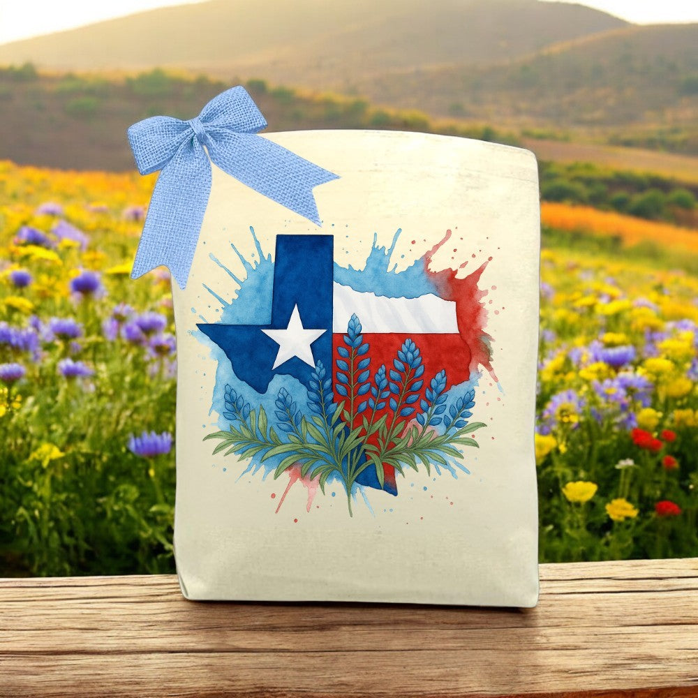 Cotton tote with a watercolor Texas and bluebonnet design. A bold, artistic accessory that celebrates Texas pride with a splash of spring color.