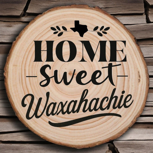 Rustic wood slice coaster with “Home Sweet Waxahachie” laser engraving, Texas silhouette, and leafy accents on wood background.