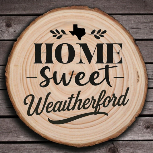 Rustic wood slice coaster with “Home Sweet Weatherford” laser engraving, Texas silhouette, and leafy accents on wood background.