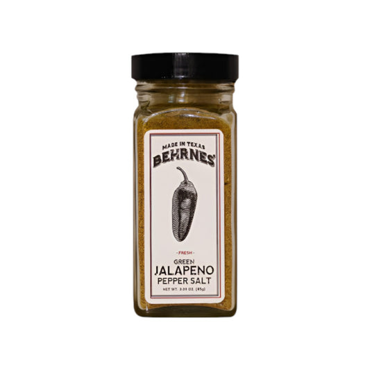 Glass spice jar of Berne’s Green Jalapeño Pepper Salt with a black lid, featuring a vintage-style white label with an illustrated jalapeño pepper and “Made in Texas” text, photographed on a white background