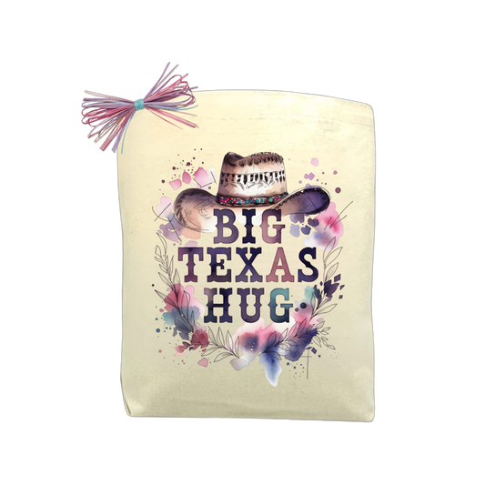 Big Texas Hug Cowgirl Edition gift tote with floral cowgirl hat design, isolated on a black background for product display.