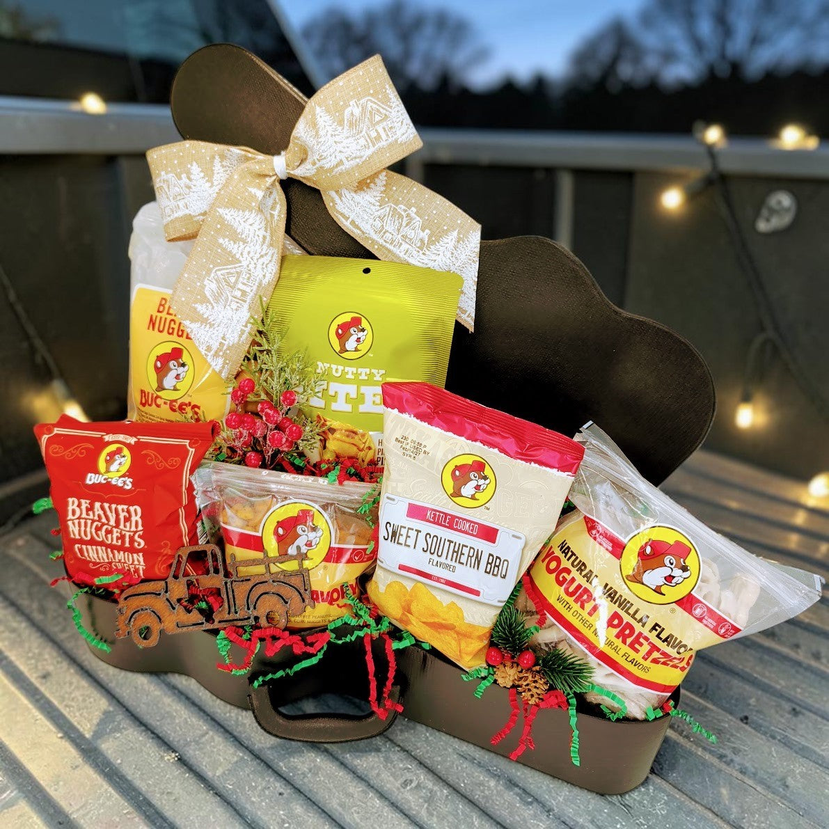 Buc-ee’s Christmas Road Trip gift with six snacks and a Texas truck magnet in a guitar case with Christmas ribbon.