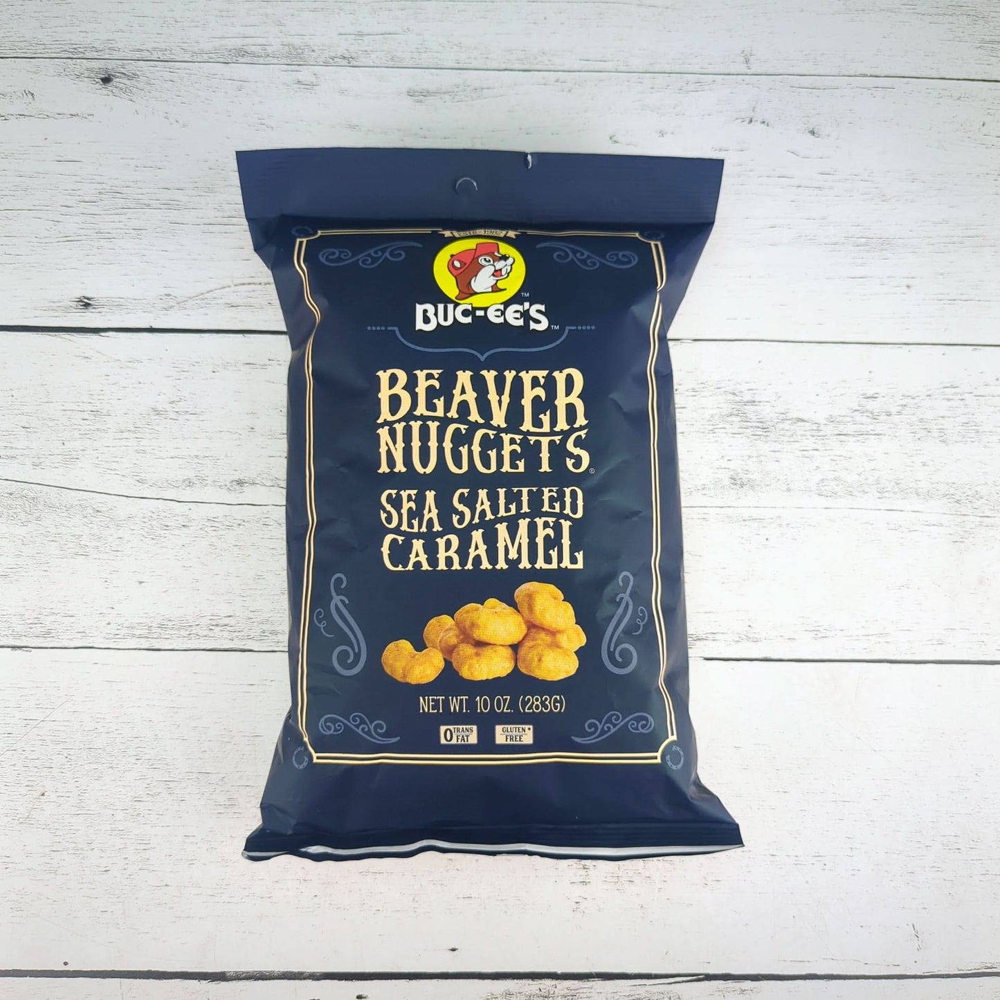 a package of bucees beaver nuggets sea salted caramel 10oz, available for inclusion in a texas-themed gift basket, box, or tote