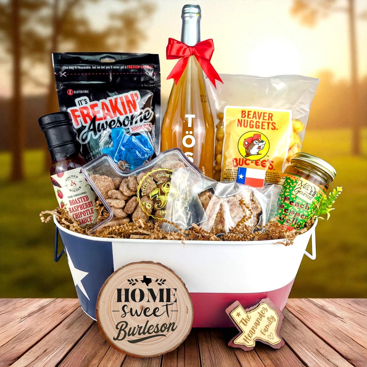 Burleson Texas Family Home Toast & Treats basket with TÖST ROSÉ, Peach Pepper Jelly, Buc-ee’s Beaver Nuggets, Texas pecans, praline, chipotle sauce, and Texas flag tin
