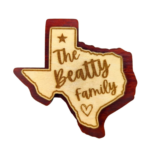 a double layered personalized magnet in the shape of texas with a custom engraved family name