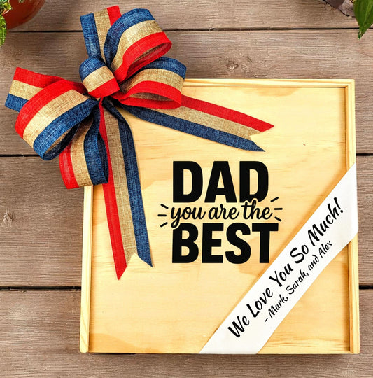 Wooden gift box with a large bow and 'Dad you are the BEST' message on a wooden surface