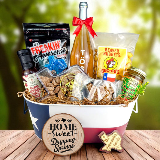 Dripping Springs Texas Homestyle Toast & Treats Basket with TÖST ROSÉ, Peach Pepper Jelly, Buc-ee’s Beaver Nuggets, Texas pecans, praline, chipotle sauce, and Texas flag tin