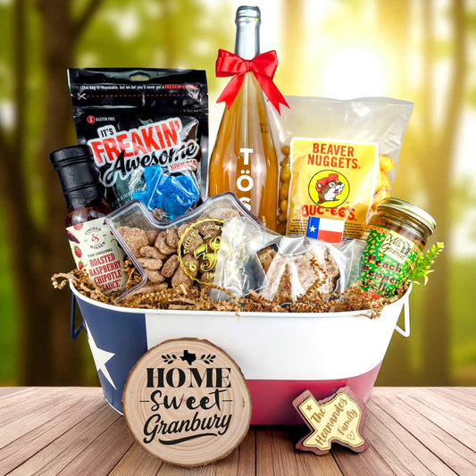 Granbury Texas Home Toast & Treats basket with TÖST ROSÉ, Peach Pepper Jelly, Buc-ee’s Beaver Nuggets, Texas pecans, praline, chipotle sauce, and Texas flag tin