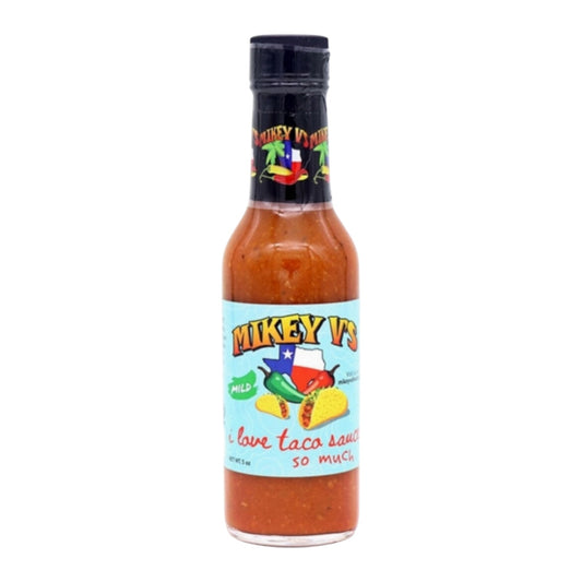 Bottle of Mikey V’s mild taco sauce with illustrated taco and pepper label