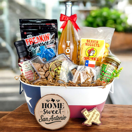 San Antonio Texas Toast & Treats Home Basket with TÖST ROSÉ, Peach Pepper Jelly, Buc-ee’s Beaver Nuggets, Texas pecans, praline, chipotle sauce, and Texas flag tin