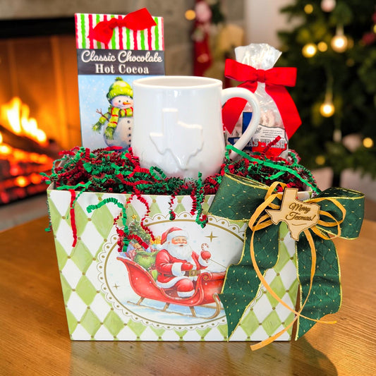 Santa’s Texas Cocoa Break Christmas gift with white Texas mug, Carmie’s cocoa and Texas Trash in a Santa basket box