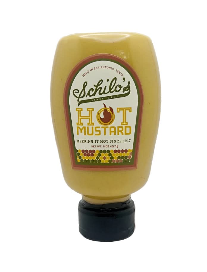 Schilo’s Hot Mustard in a classic jar, highlighting its bold, tangy flavor, displayed on a wooden table as part of a Texas gift collection.