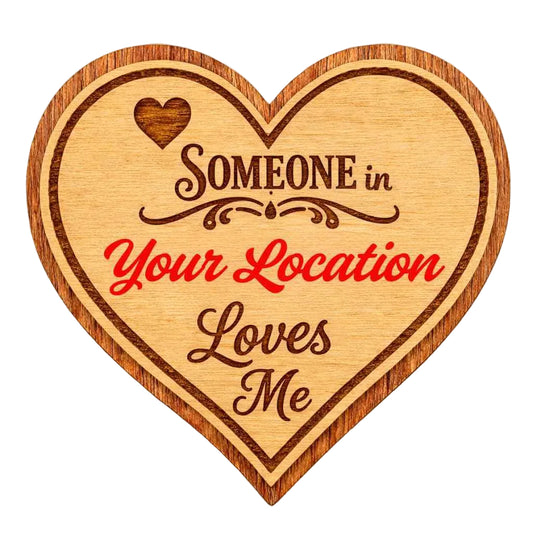 Wooden heart-shaped magnet with engraved text on a white background
