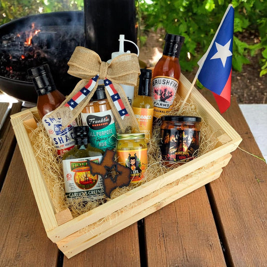 A generous gift crate brimming with Texas BBQ treats, including BBQ seasoning, fiery mustard, BBQ sauce, salsa, and glaze