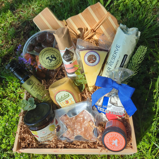 a deluxe texas-themed and texas-sourced charcuterie wood gift box filled with gourmet Texas Food and Texas-shaped cheese board