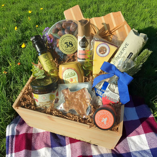 a Texas Rancher-themed wood gift box filled with Texas-sourced specialty foods icluding artisan cheese, candied pecans, praline, honey, and preserves