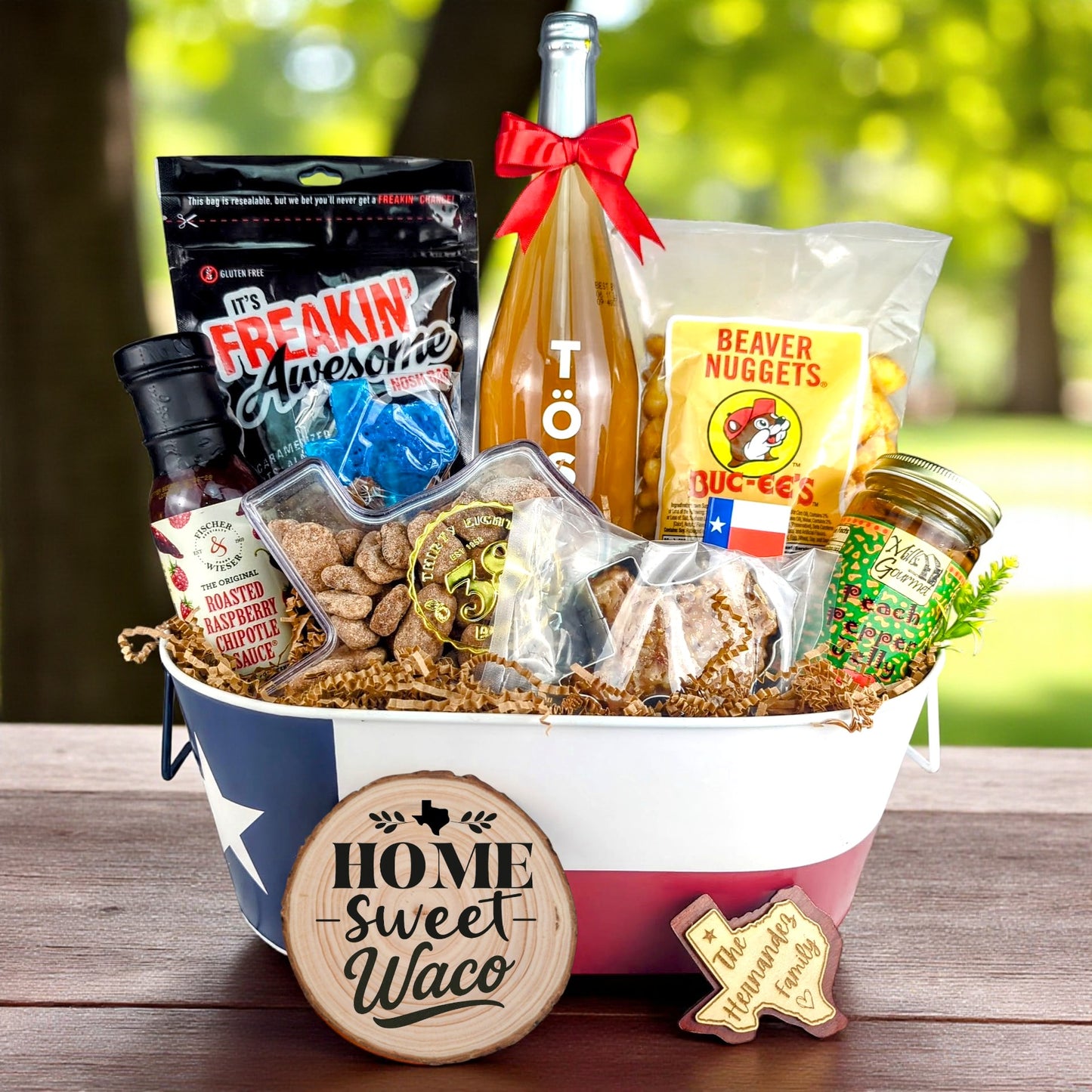 Waco Texas Home Toast & Treats basket with TÖST ROSÉ, Peach Pepper Jelly, Buc-ee’s Beaver Nuggets, Texas pecans, praline, chipotle sauce, and Texas flag tin