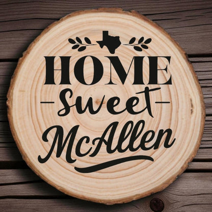 Rustic wood slice coaster with “Home Sweet McAllen” laser engraving, Texas silhouette, and leafy accents on wood background.