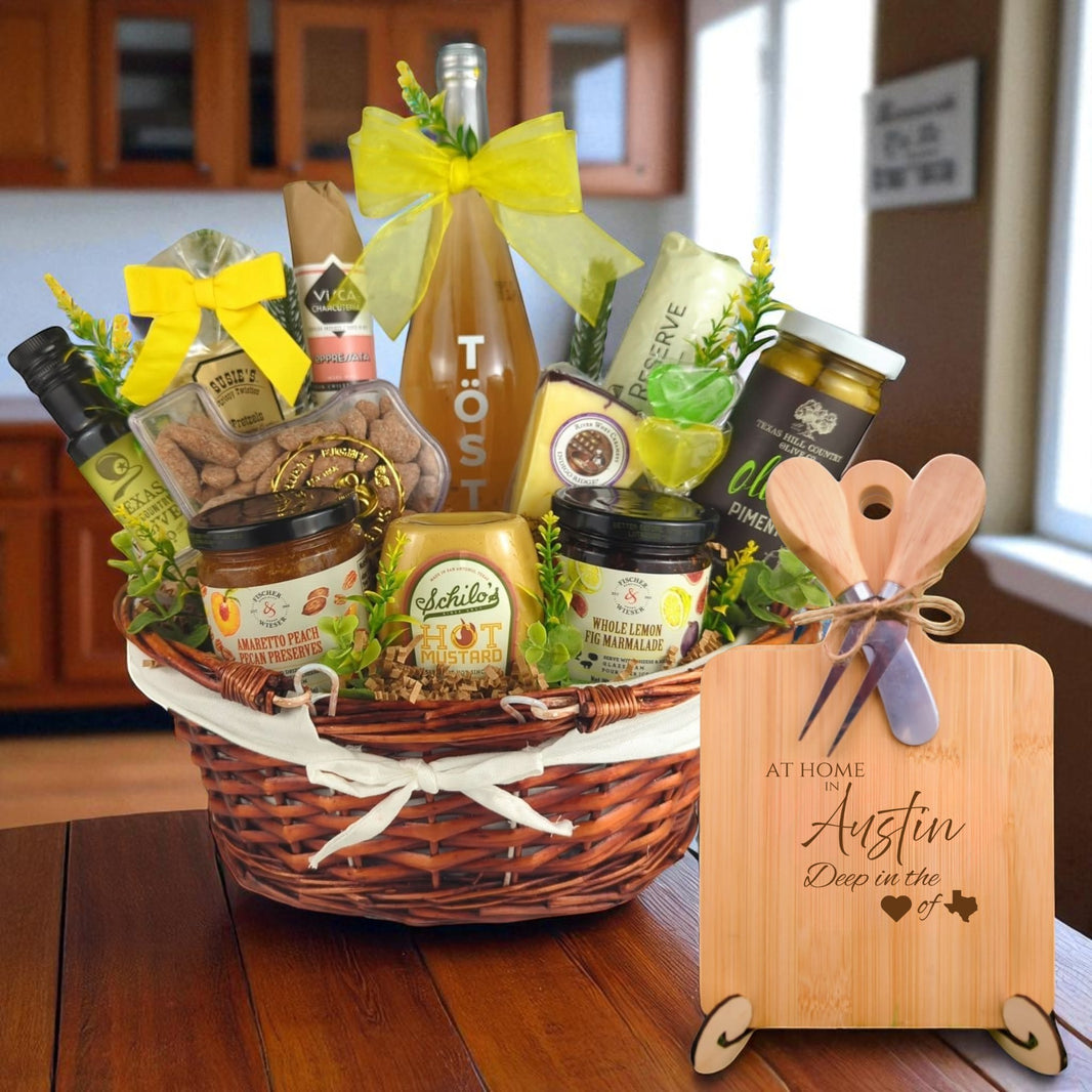 A beautifully arranged gourmet gift basket paired with the At Home in Austin Charcuterie Board, featuring bamboo wood, rustic utensils, and engraved Texas design, perfect for celebrating Austin’s vibrant spirit.