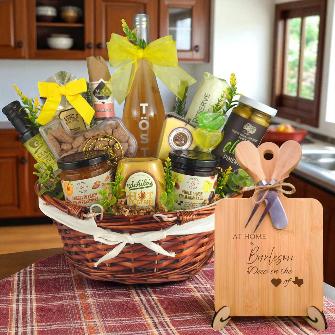 A gourmet gift basket paired with the At Home in Burleson Charcuterie Board, featuring bamboo wood, rustic utensils, and engraved Texas design, perfect for celebrating Burleson’s community spirit.