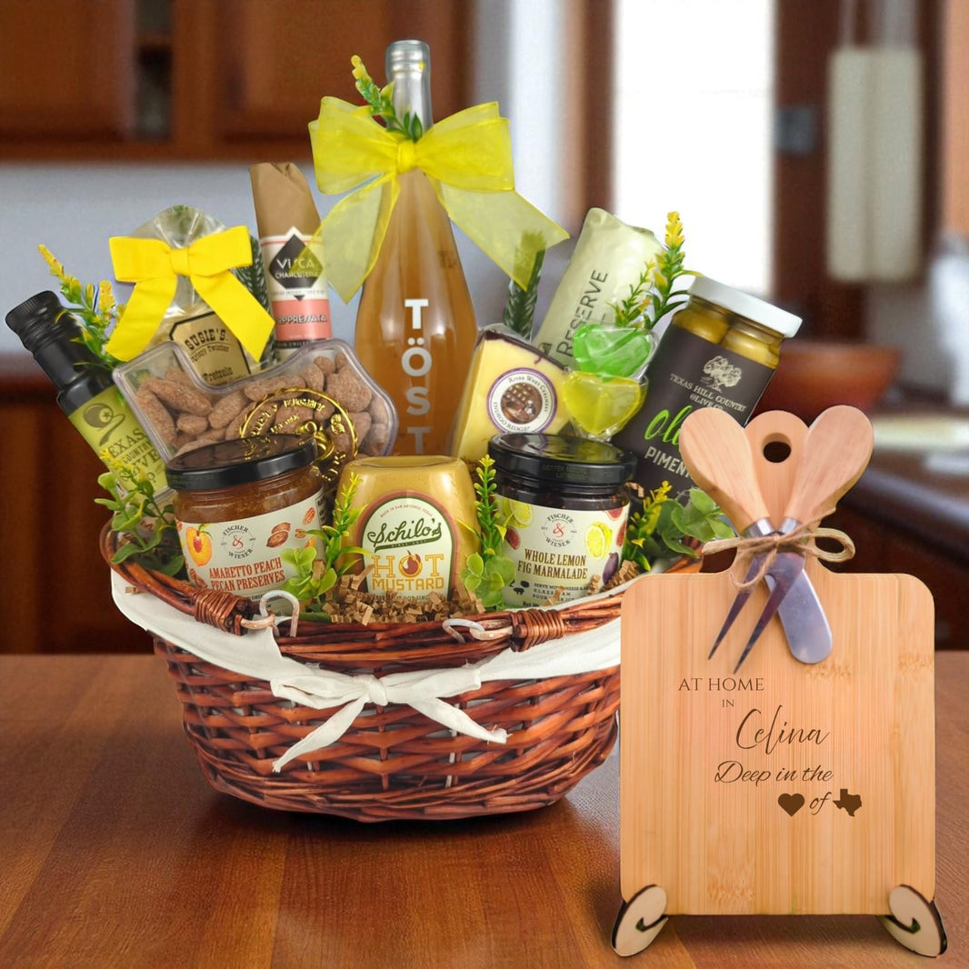 A gourmet gift basket paired with the At Home in Celina Charcuterie Board, featuring bamboo wood, rustic utensils, and engraved Texas design, perfect for celebrating Celina’s community spirit.