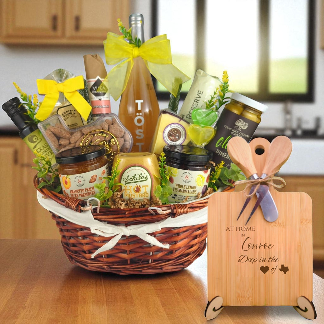 A gourmet gift basket paired with the At Home in Conroe Charcuterie Board, featuring bamboo wood, rustic utensils, and engraved Texas design, perfect for celebrating Conroe’s community spirit.