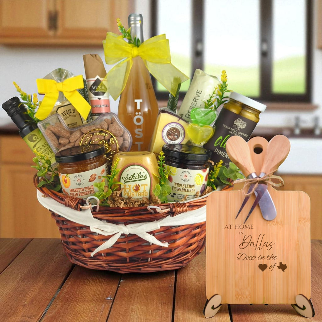 A gourmet gift basket paired with the At Home in Dallas Charcuterie Board, featuring bamboo wood, rustic utensils, and engraved Texas design, perfect for celebrating Dallas’s vibrant community.