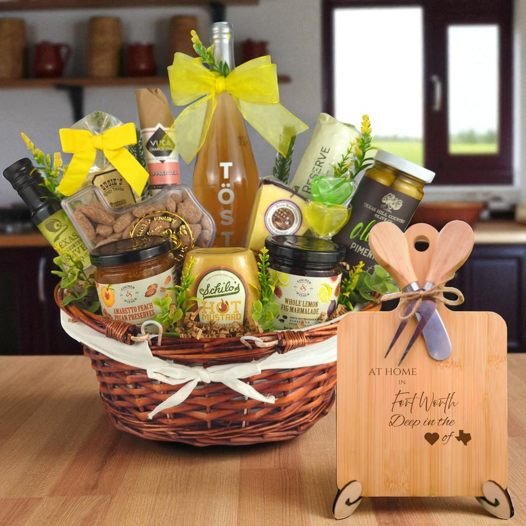 A gourmet gift basket paired with the At Home in Fort Worth Charcuterie Board, featuring bamboo wood, rustic utensils, and engraved Texas design, perfect for celebrating Fort Worth’s rich Texas heritage.
