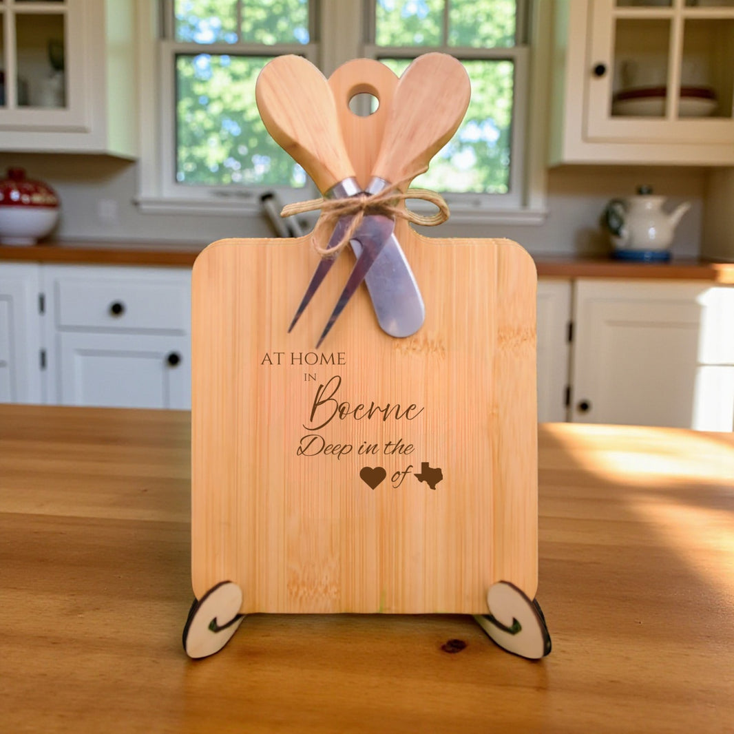 Bamboo charcuterie board engraved with “At Home in Boerne, Deep in the Heart of Texas” displayed in a bright kitchen setting.